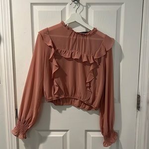Cropped pink ruffled blouse